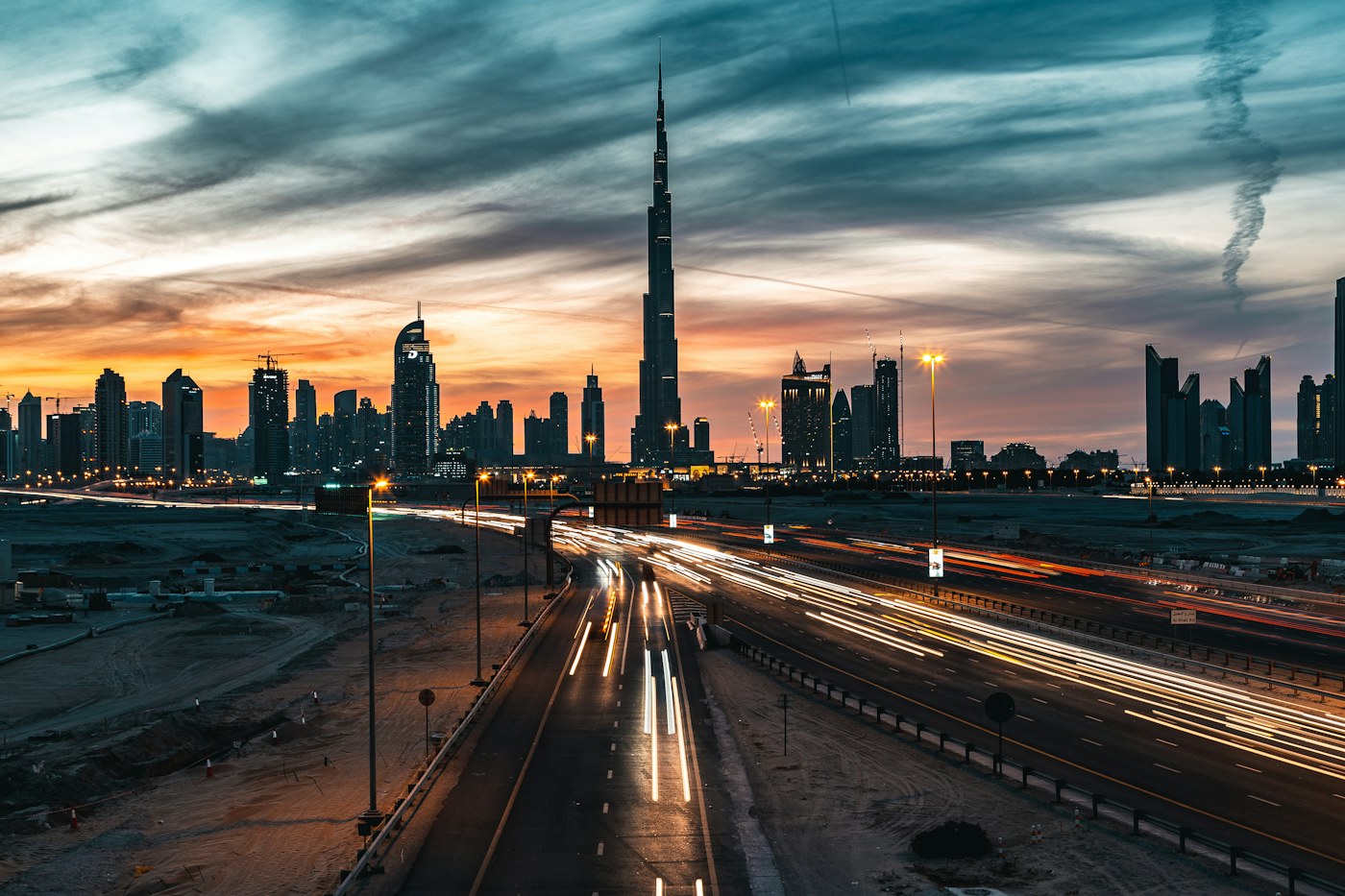 Dubai skyline at dusk with highway light trails